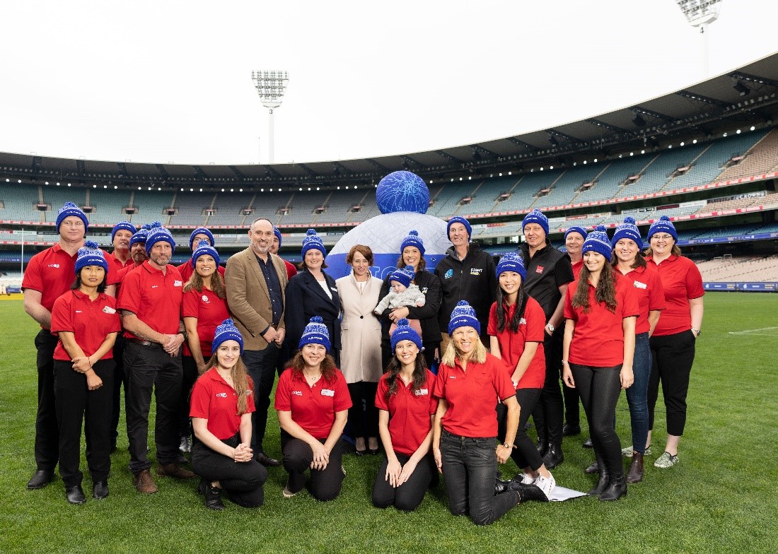 Coles and APL staff wearing fight MND beanies. 